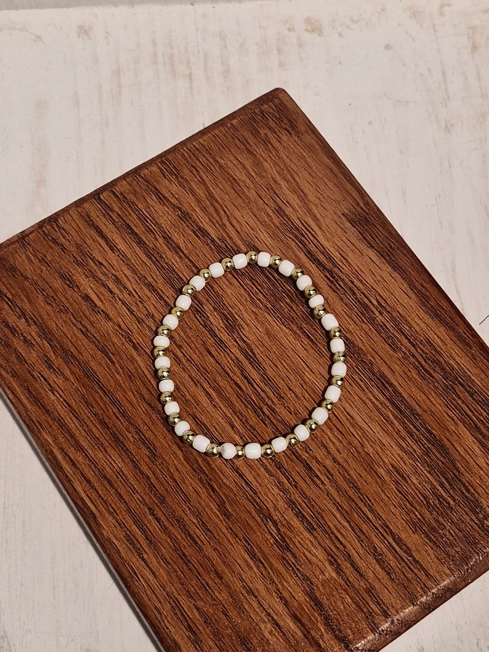 White Bead Stretch Bracelet with Gold Accent Beads